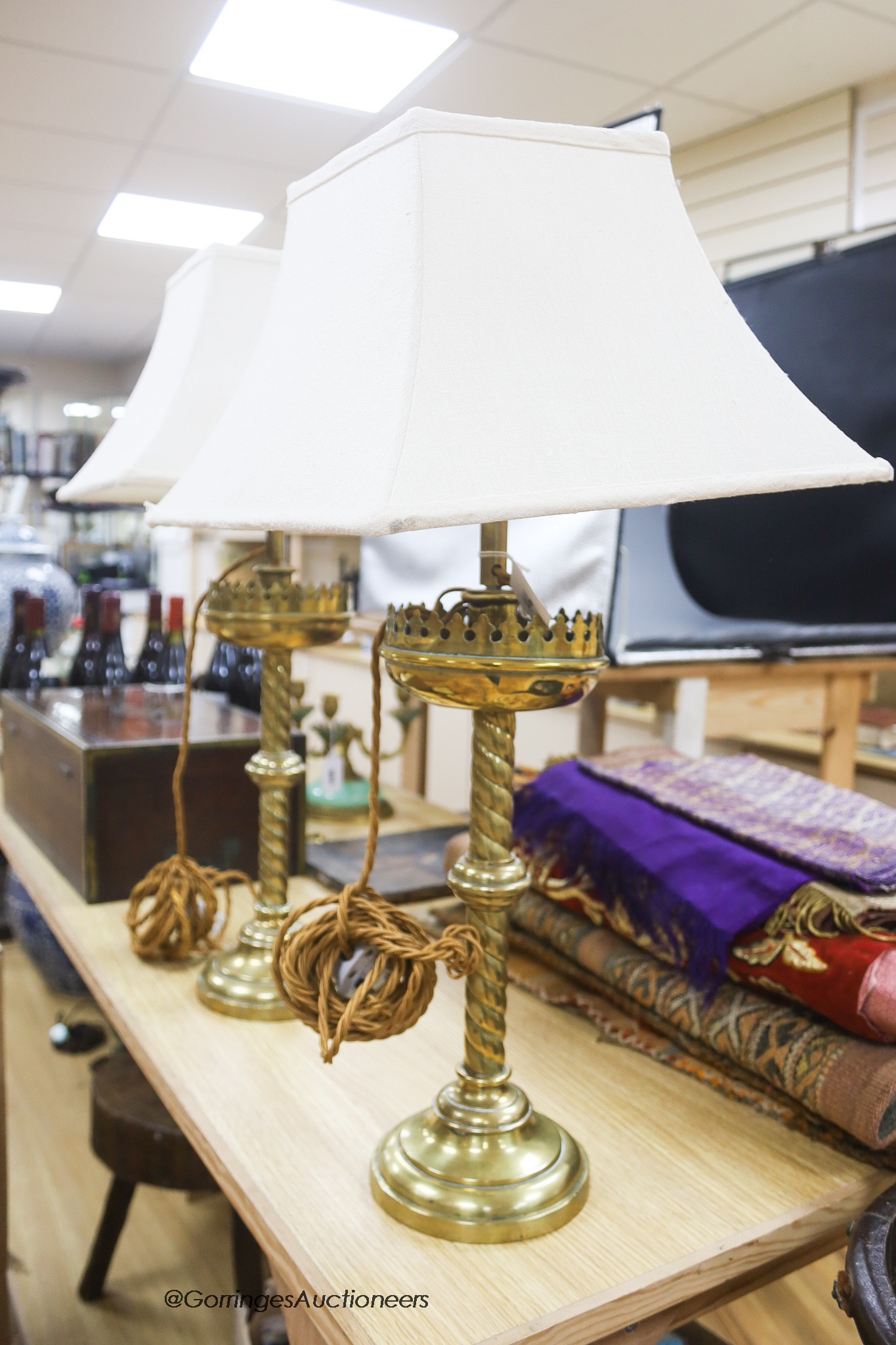 A pair of ecclesiastical brass lamps, later converted, height 37cm